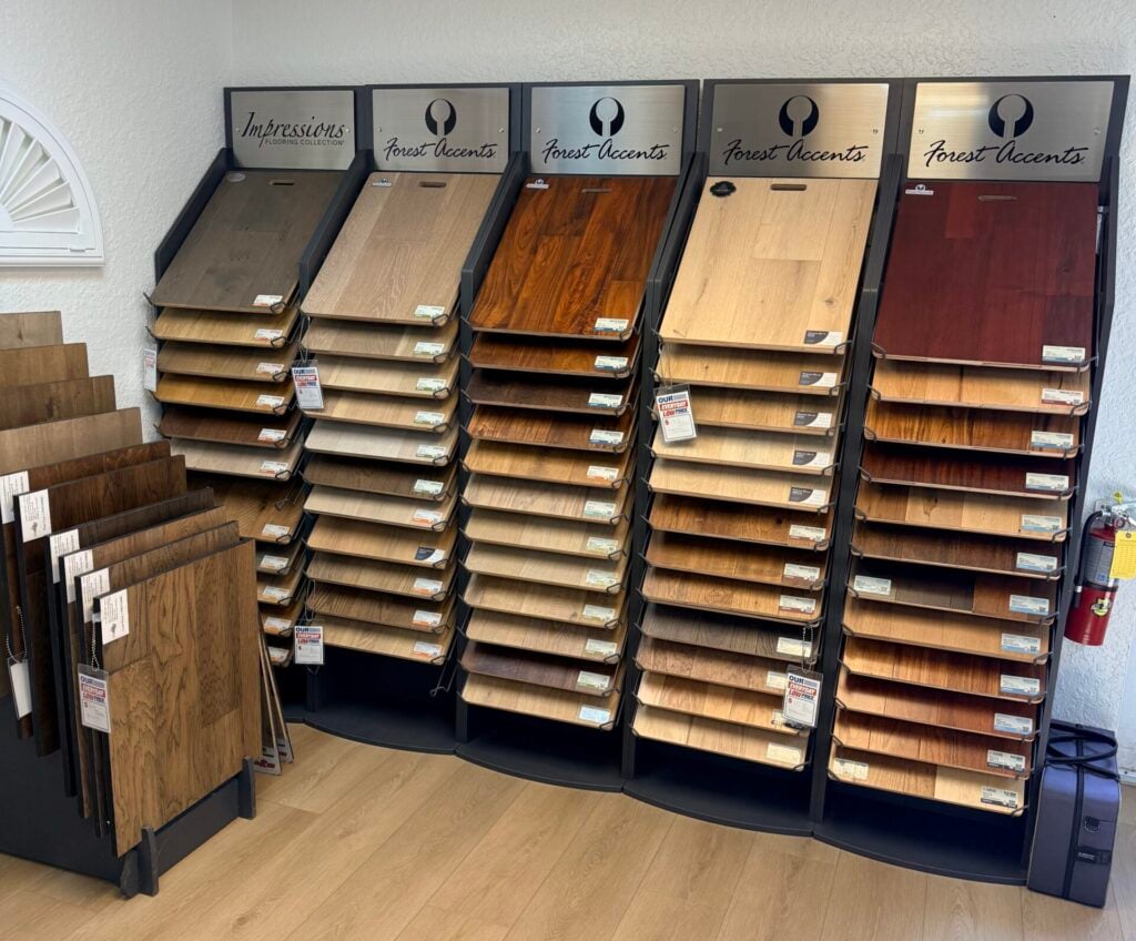 A showroom displaying different brands of wood flooring samples.