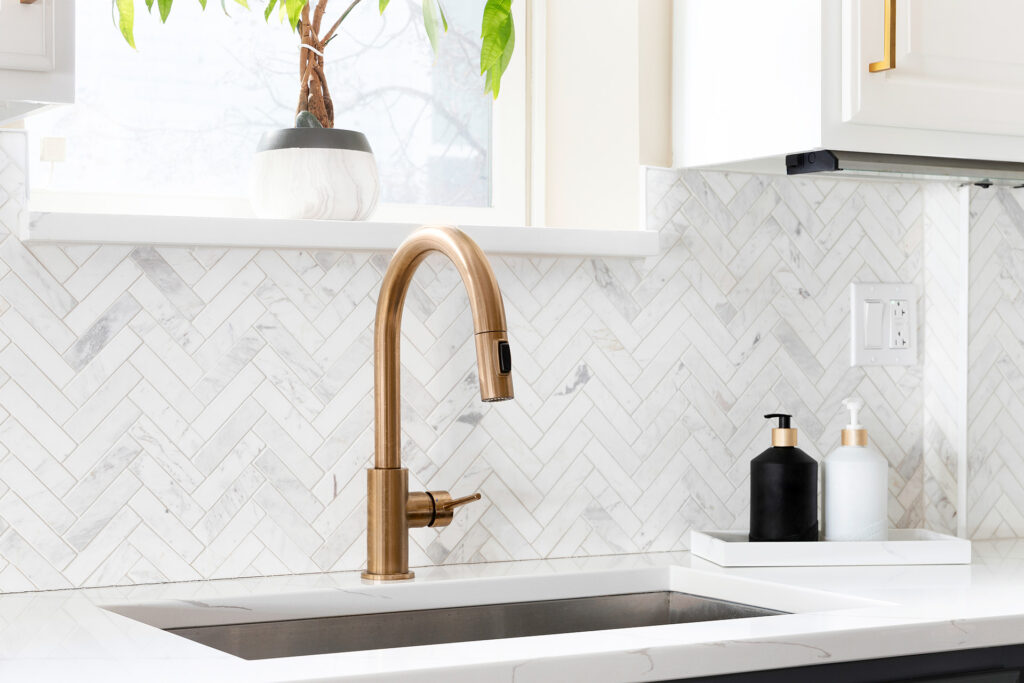 Kitchen sink with tile backsplash.